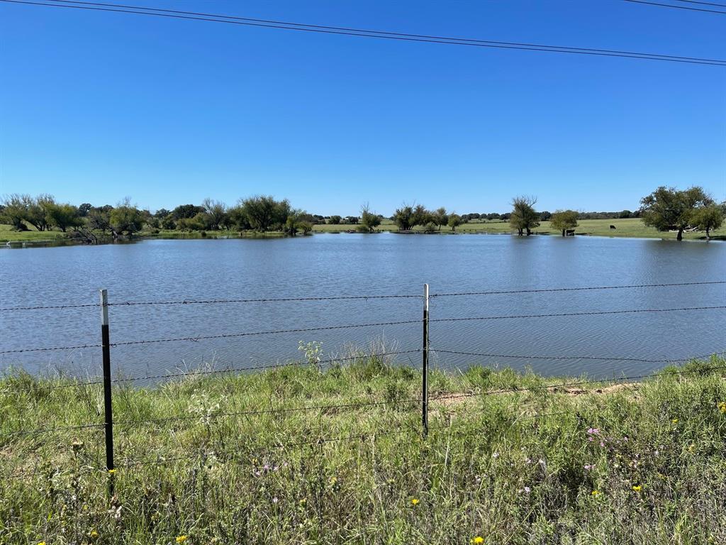 a view of a yard next to a lake