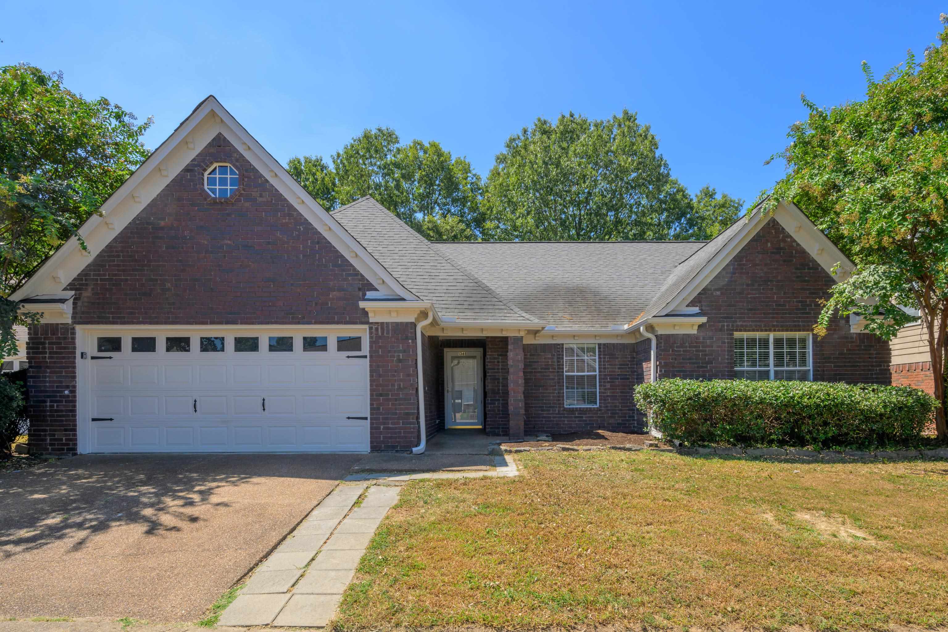 View of front of house featuring a front yard and a garage