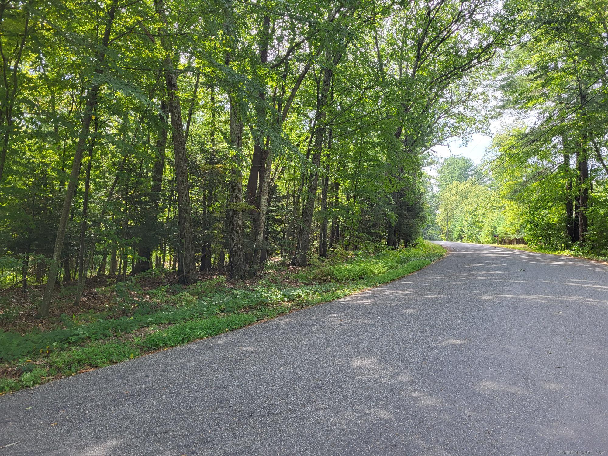 a view of a field with trees in front of it