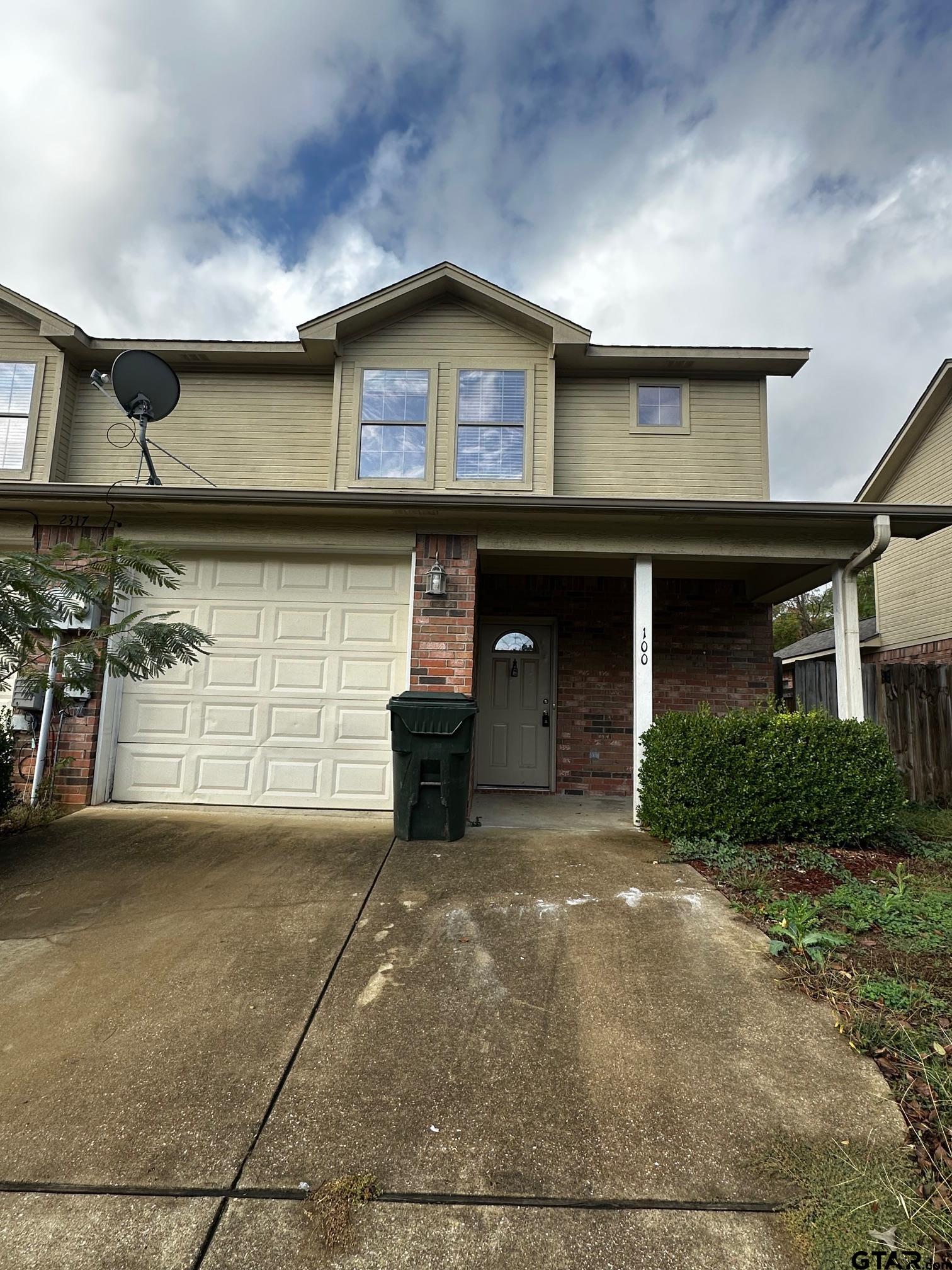 a front view of a house with a garage