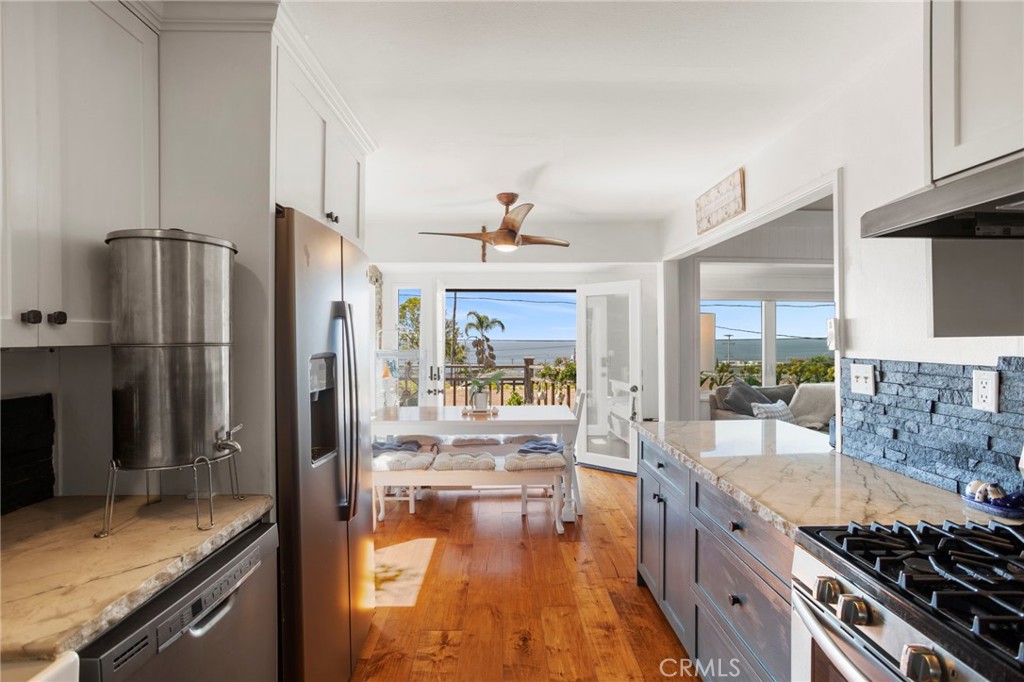 a kitchen with stainless steel appliances granite countertop a refrigerator and a sink