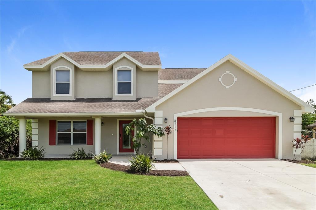 a front view of a house with a yard and garage