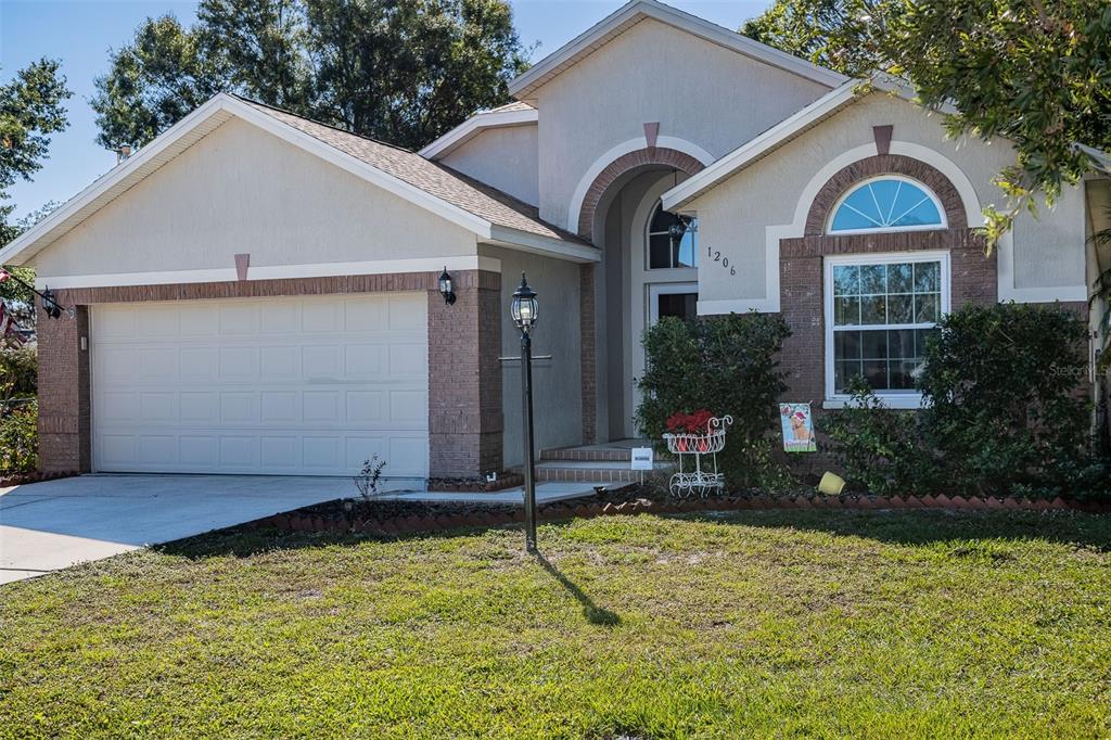 a view of house with yard