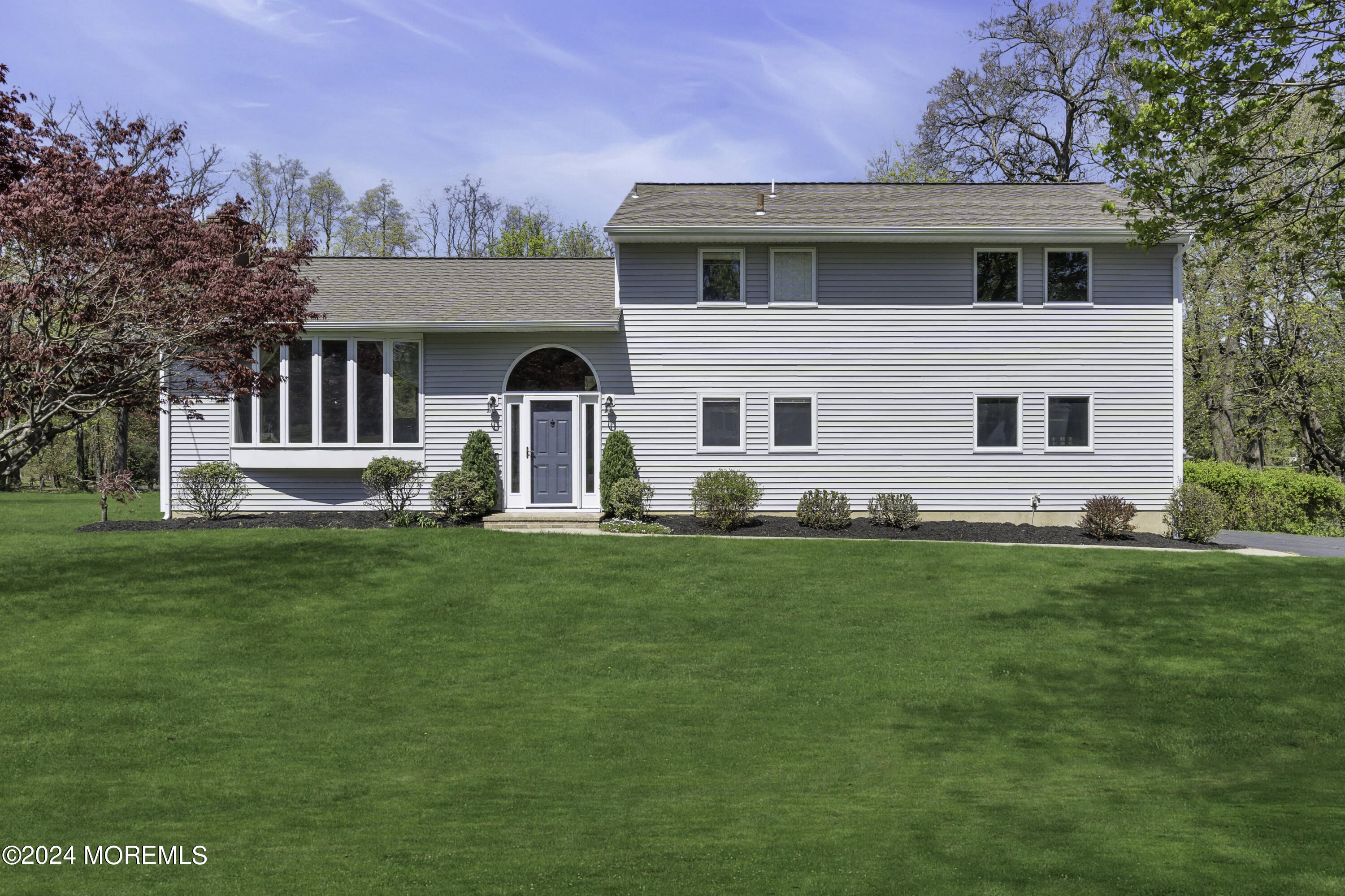 a front view of house with yard and green space