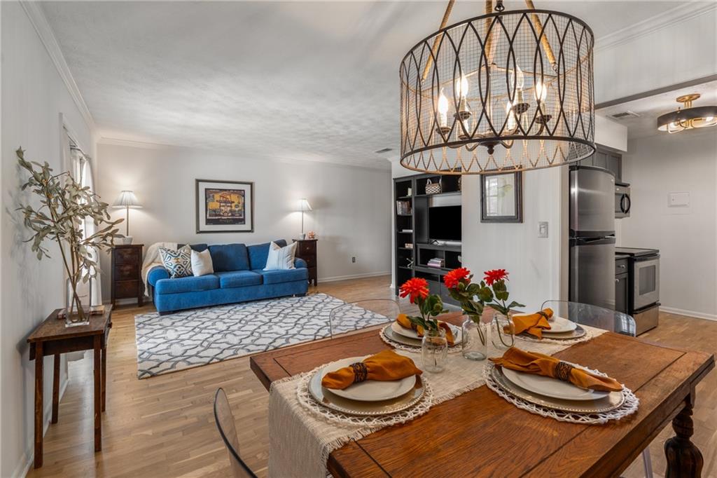 a living room with dining table and chairs