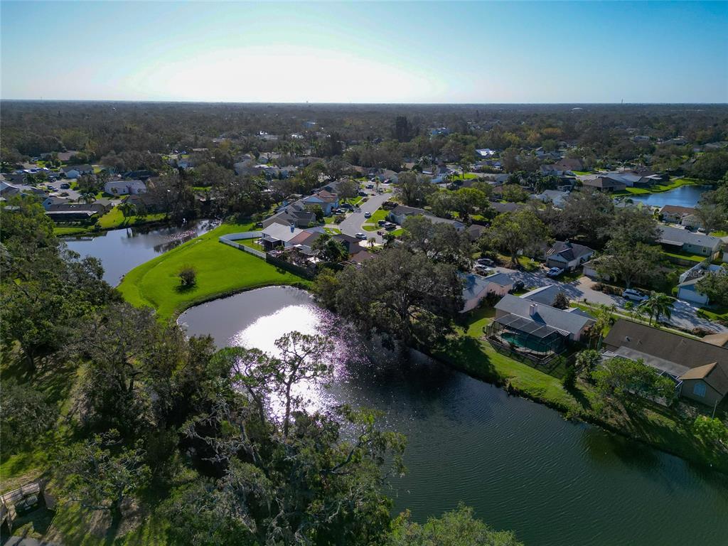 an aerial view of a city with lots of residential buildings lake and ocean view