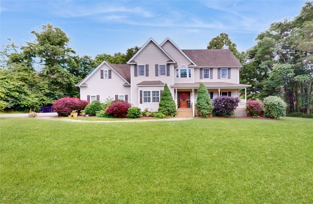 a front view of house with yard and green space