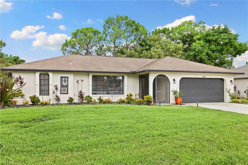 Single story home featuring a 2 car attached garage and a front lawn