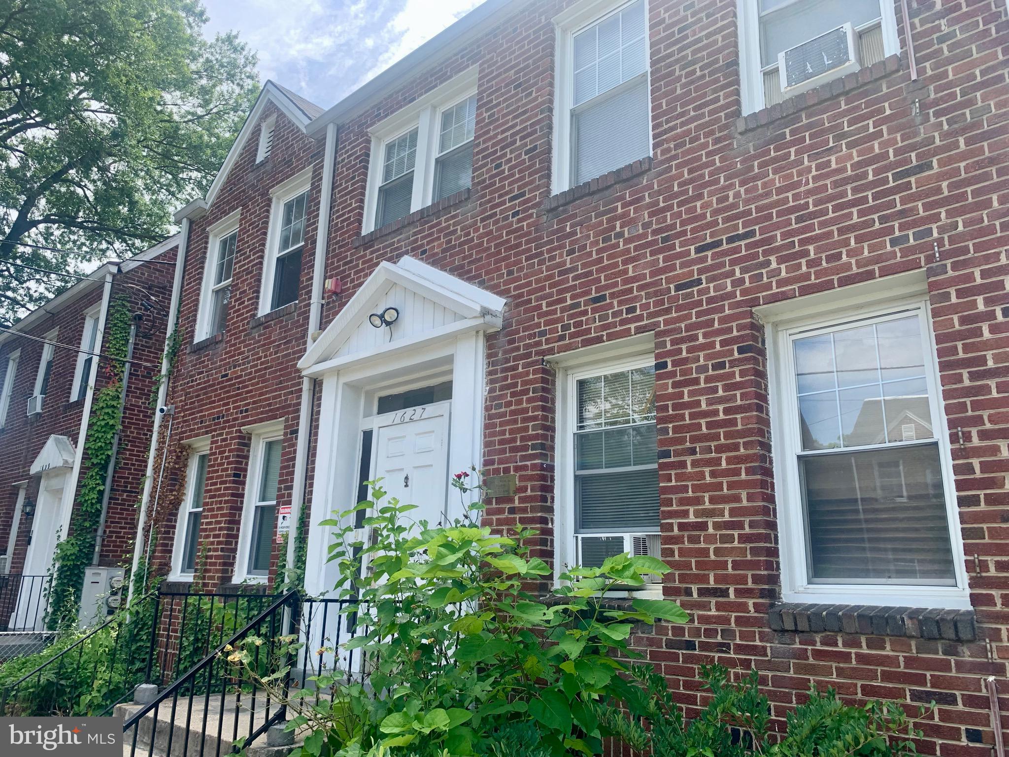 a view of a brick building next to a yard