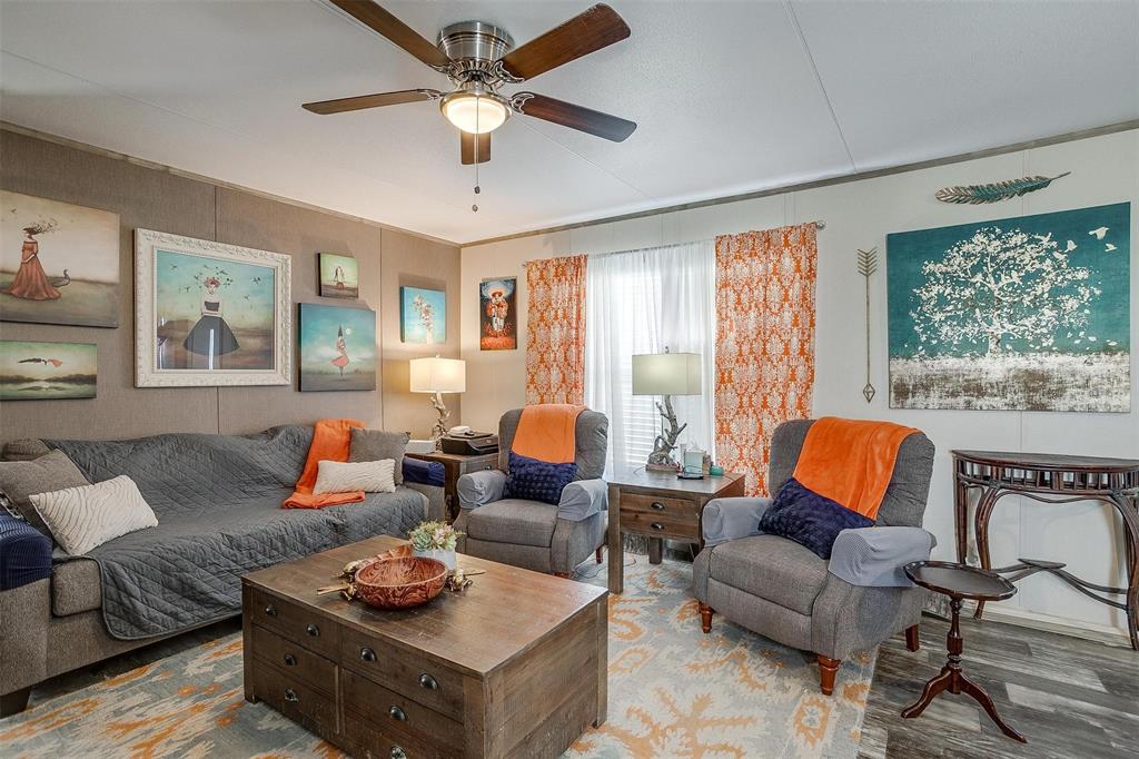 a living room with furniture a rug and a window