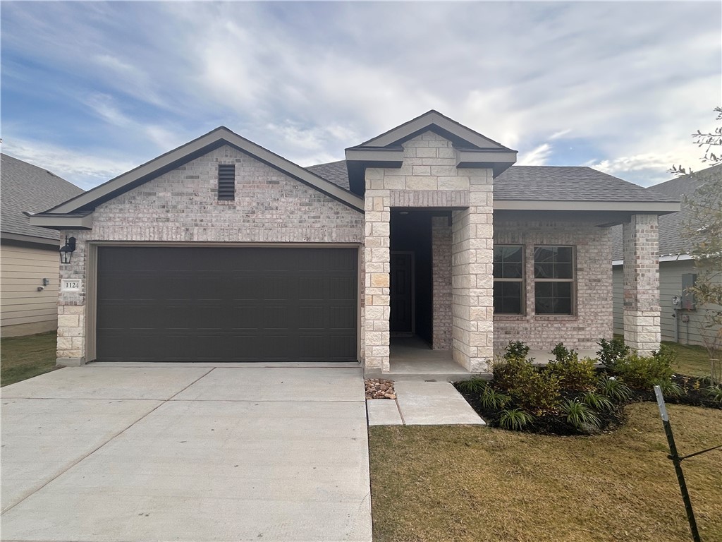 View of front of home featuring a garage and a fro