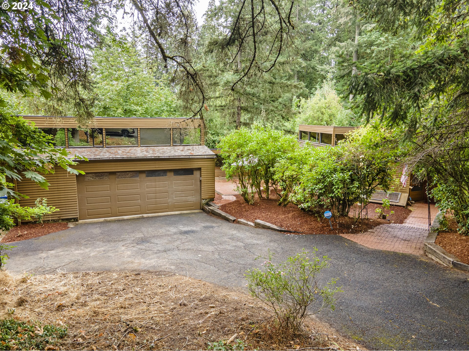 a view of a house with a yard and garage