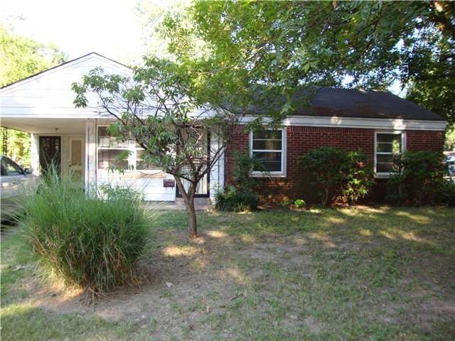 View of front of property featuring a carport