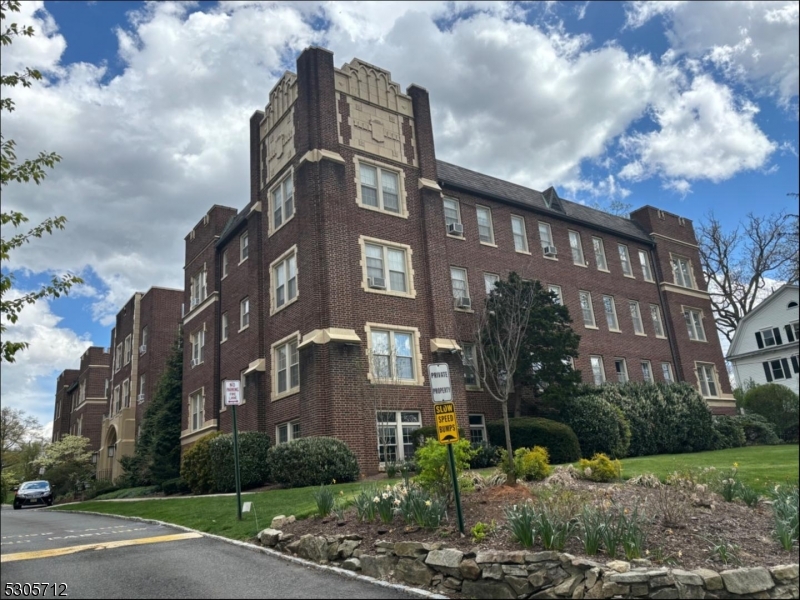 a view of a brick building next to a yard