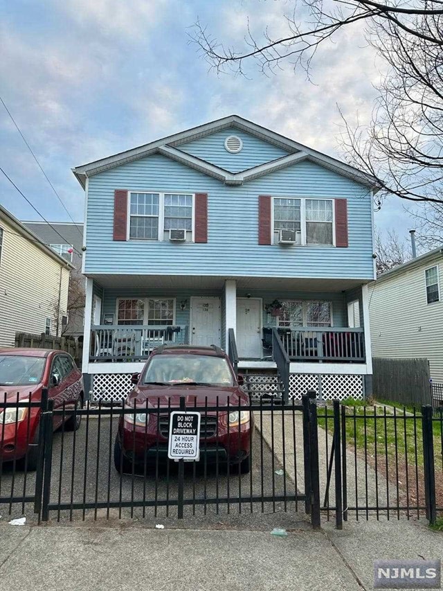 a front view of a house with parking space