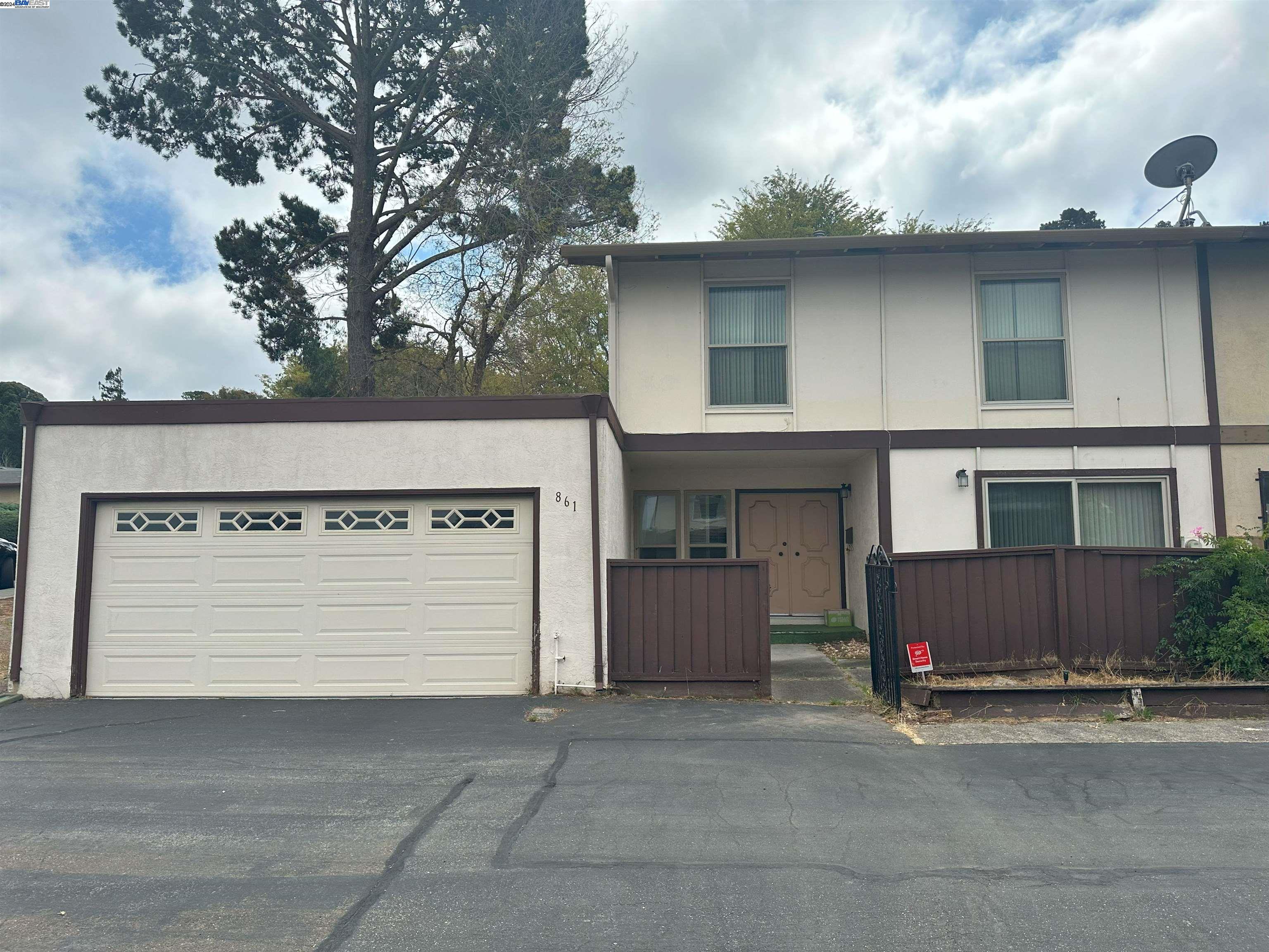 a front view of a house with a garage