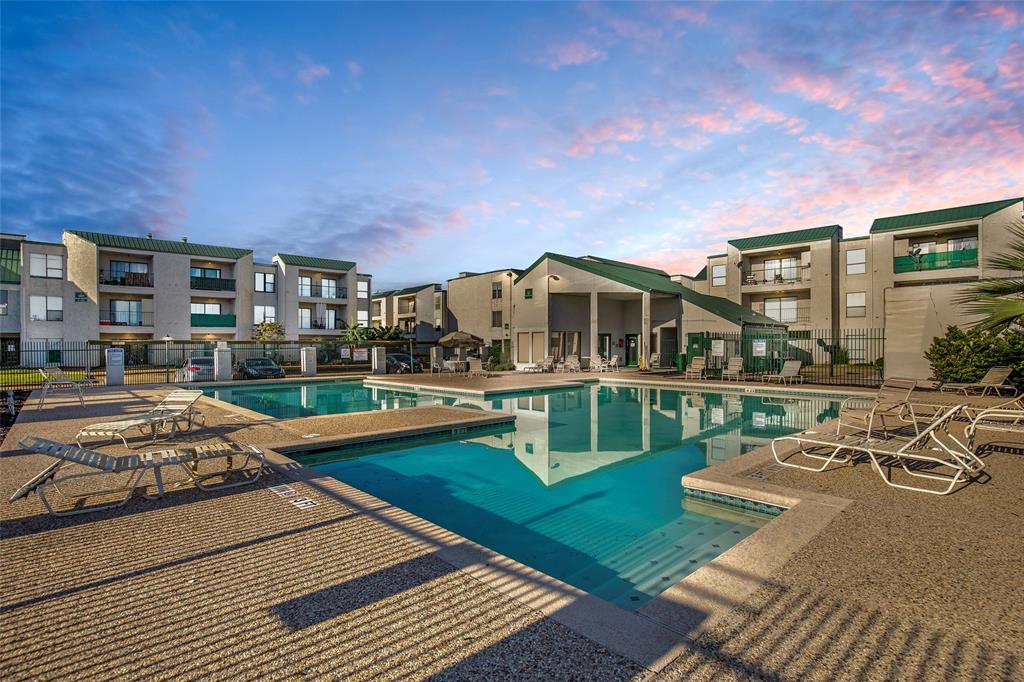 Enjoy a resort-like experience with this expansive pool area, perfect for relaxation and entertaining. The surrounding lounge chairs and clear blue water create an inviting atmosphere.