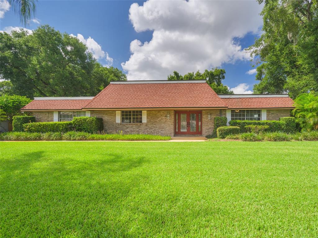 a front view of a house with a garden