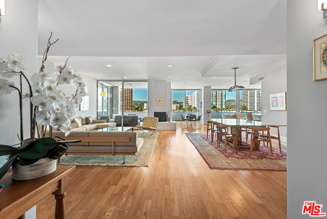 a living room with fireplace furniture and a table