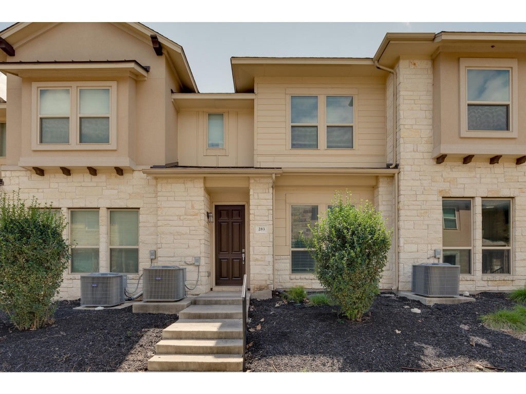 a front view of a house with a garden