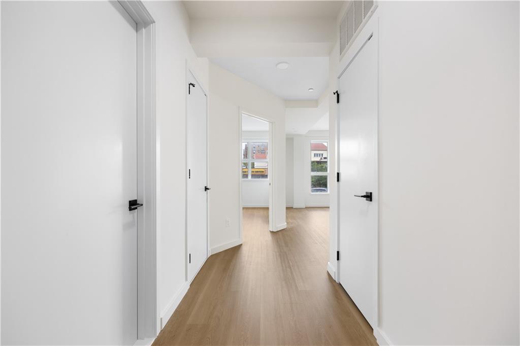 a view of a hallway with wooden floor