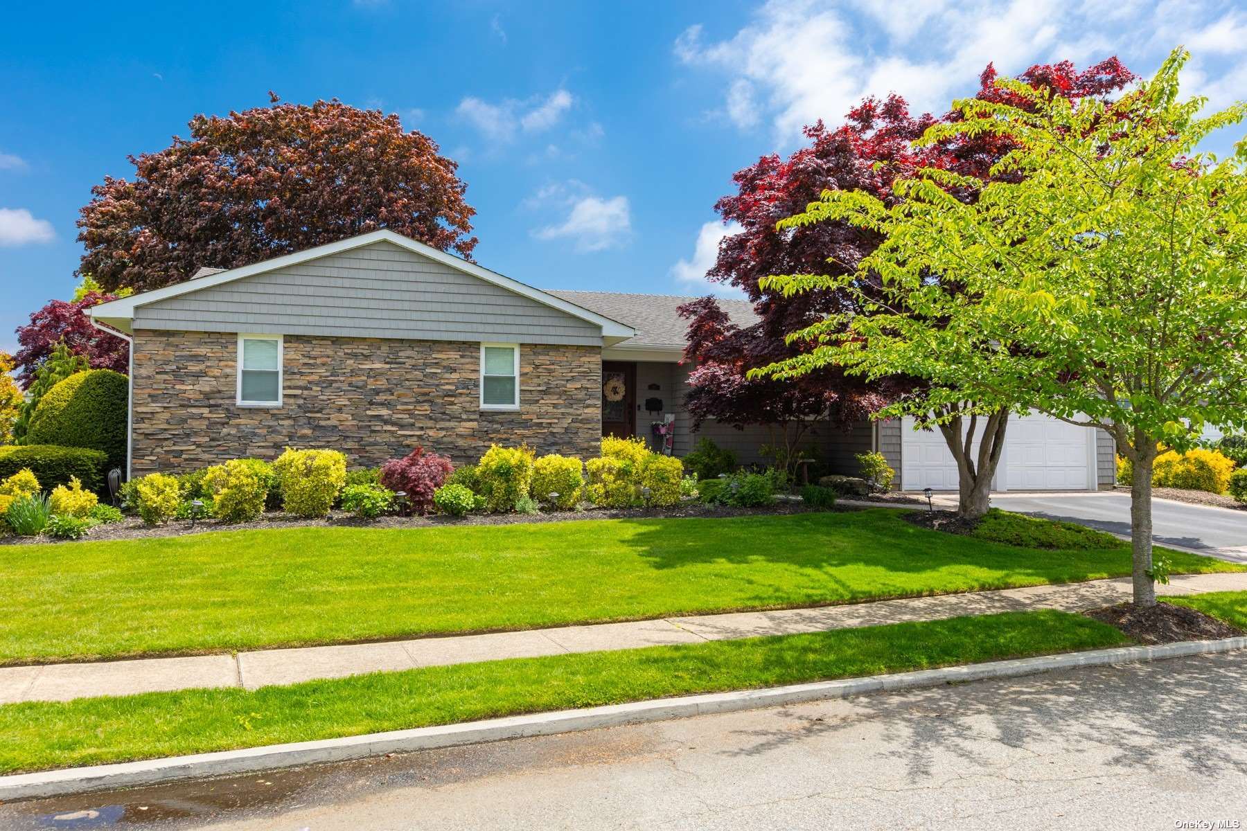 a front view of a house with a garden