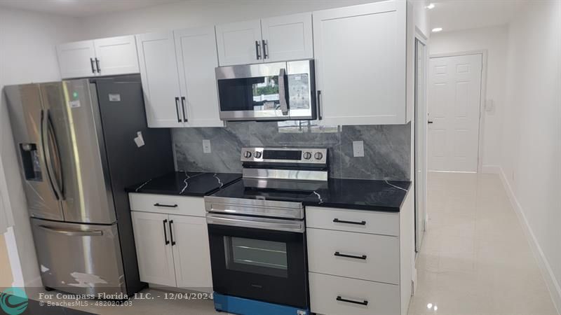 a kitchen with a stove microwave and refrigerator