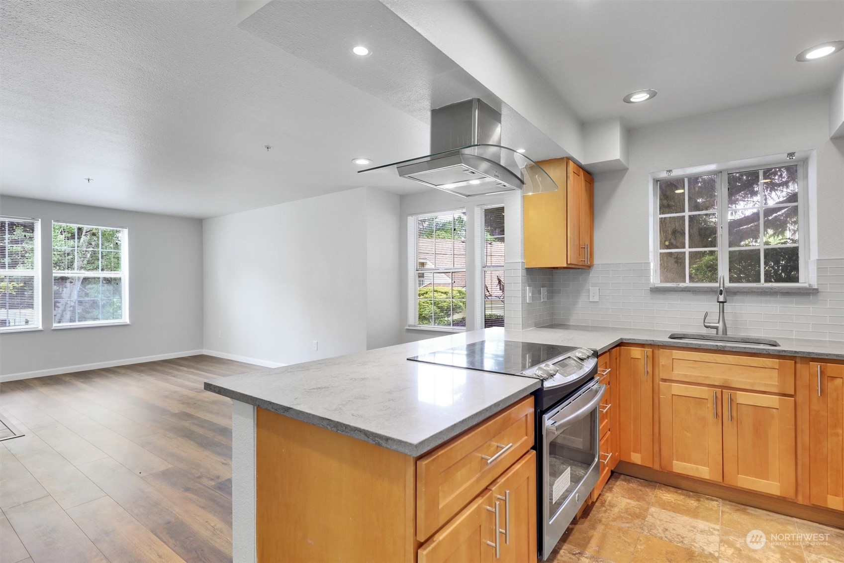 a kitchen with a sink stove and cabinets