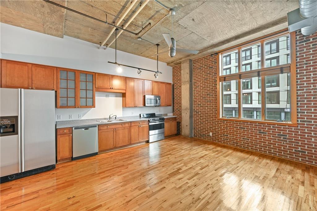 a kitchen with stainless steel appliances a refrigerator and a sink