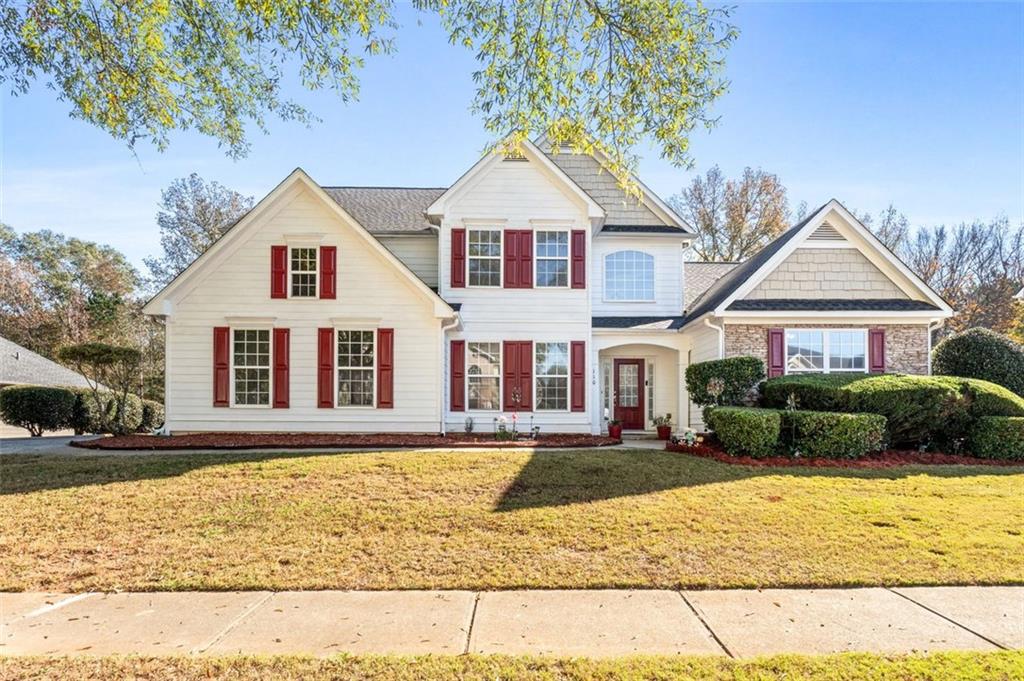 a front view of a house with a yard