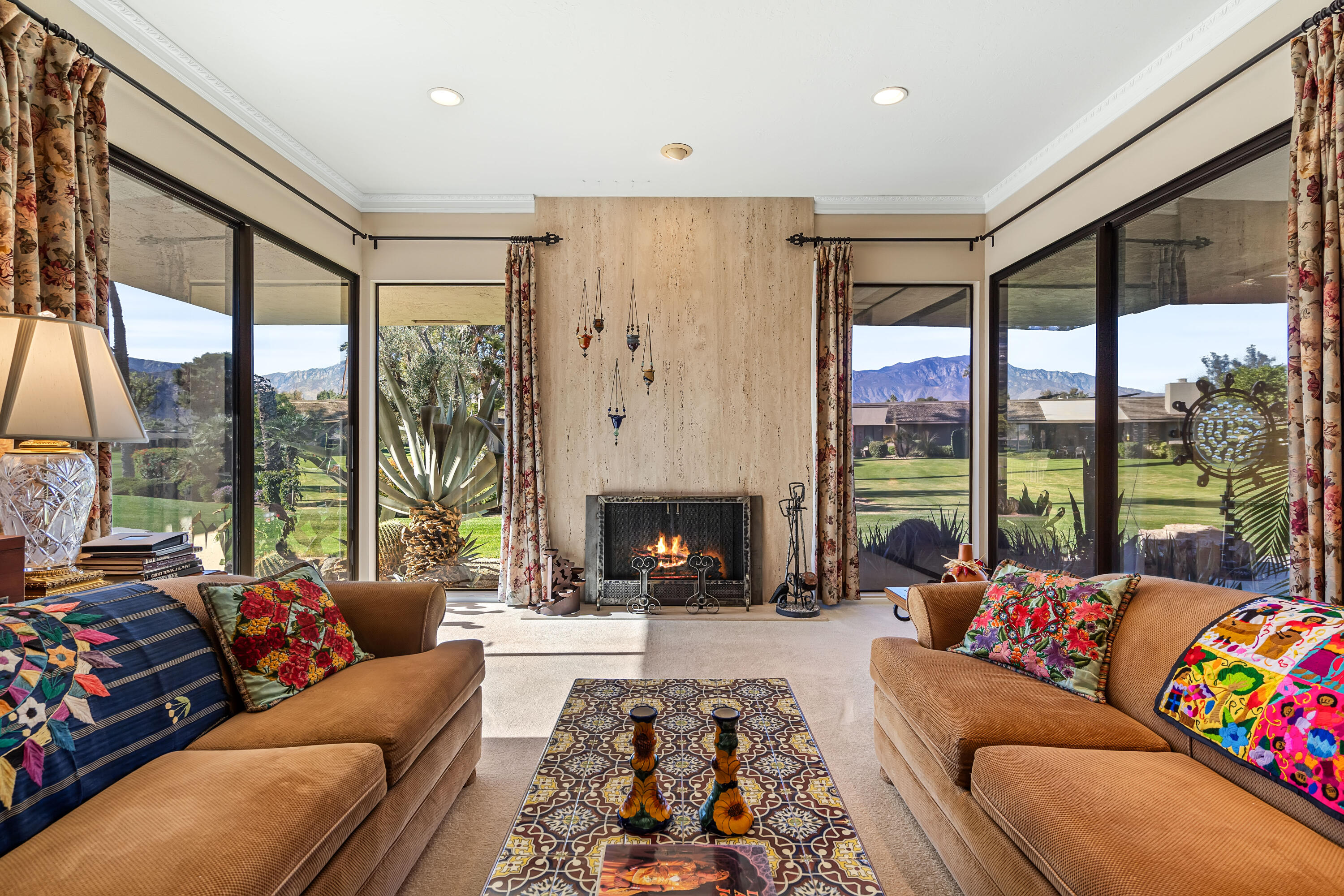 a living room with furniture fireplace and a large window