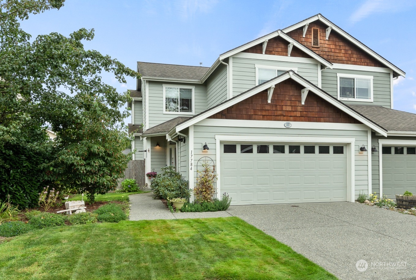 a front view of a house with a yard and trees