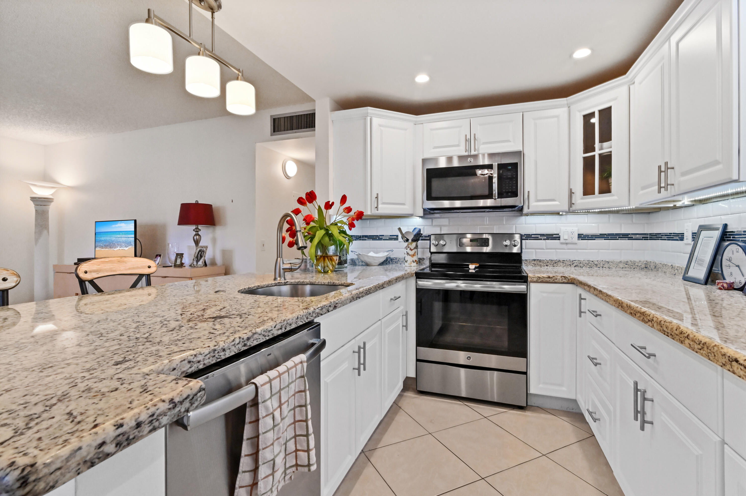 a kitchen with granite countertop a sink and cabinets