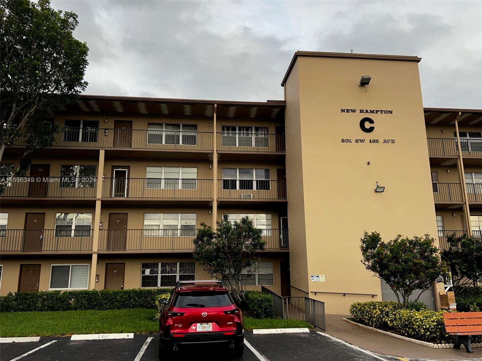 a front view of a residential apartment building with a yard