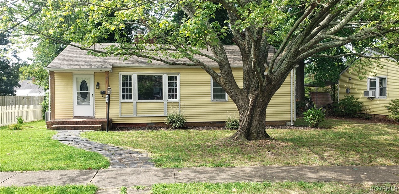 a view of a house with yard and a tree