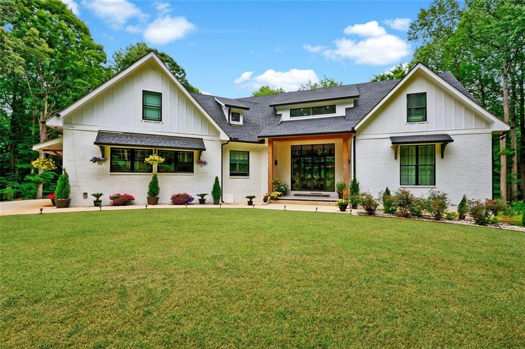 a front view of house with yard and green space