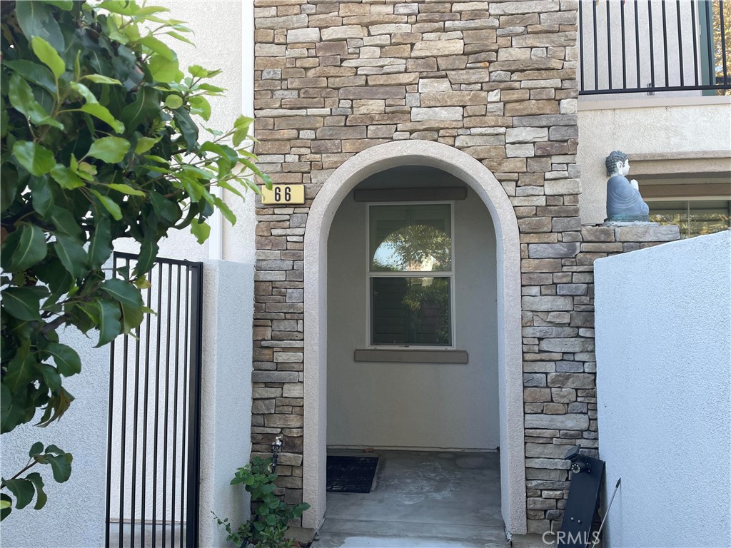 a front view of a house with plants