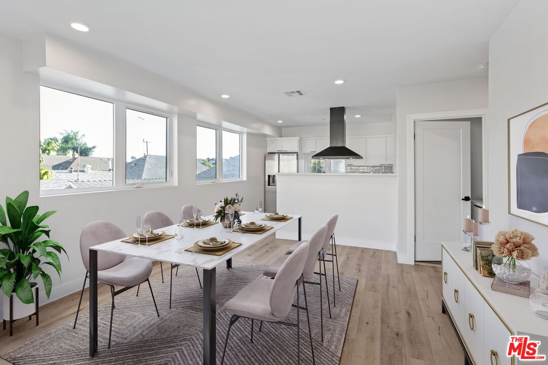 a view of a dining room with furniture window and wooden floor