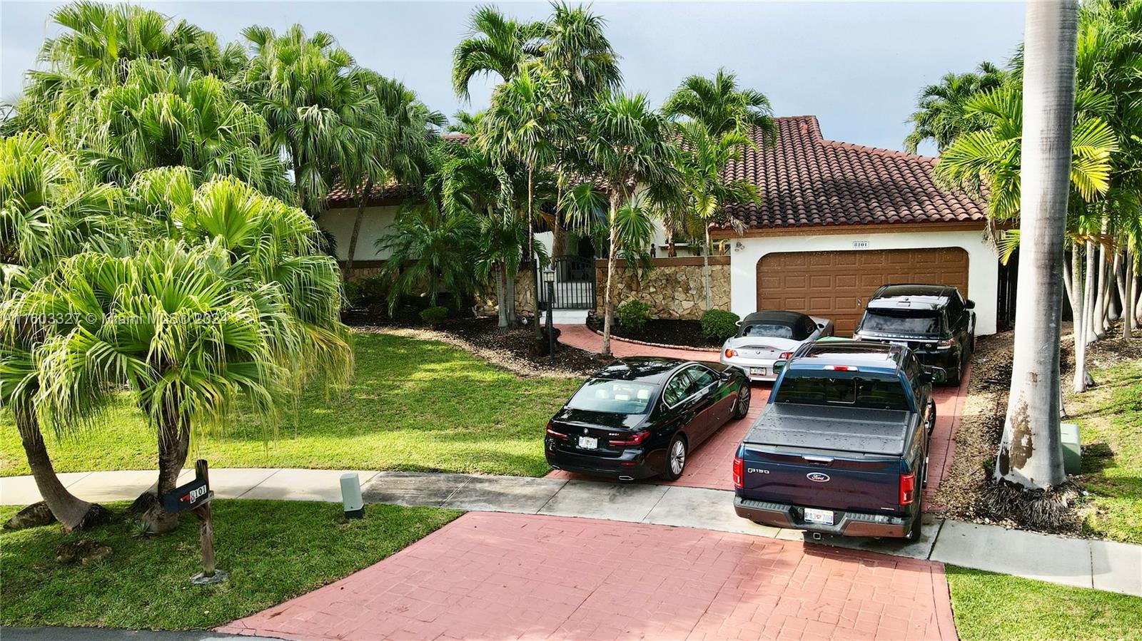 a car parked in front of a house with a yard