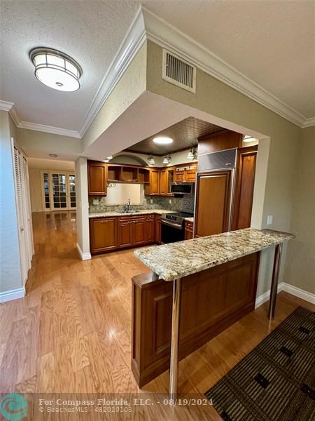 a kitchen with stainless steel appliances granite countertop a stove and a refrigerator