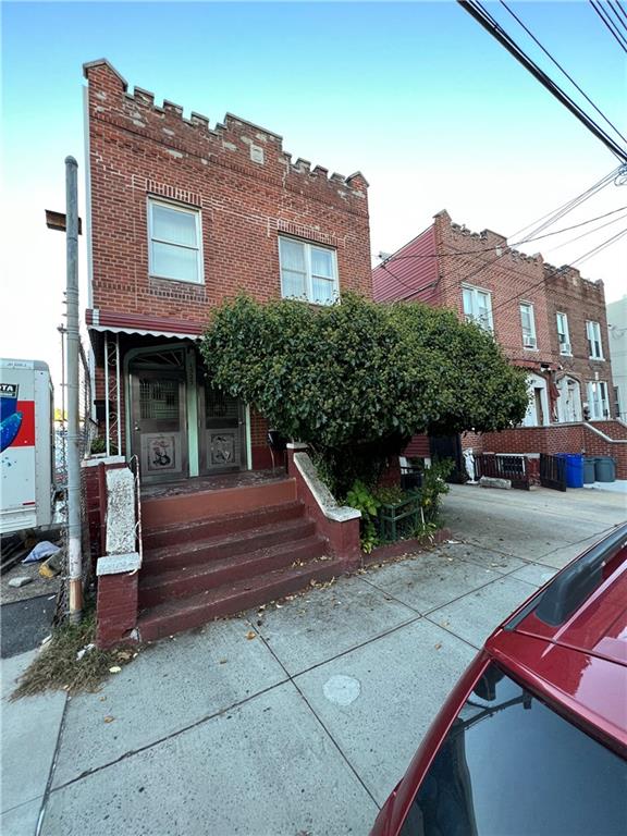 a view of a brick house with a bench in front of it