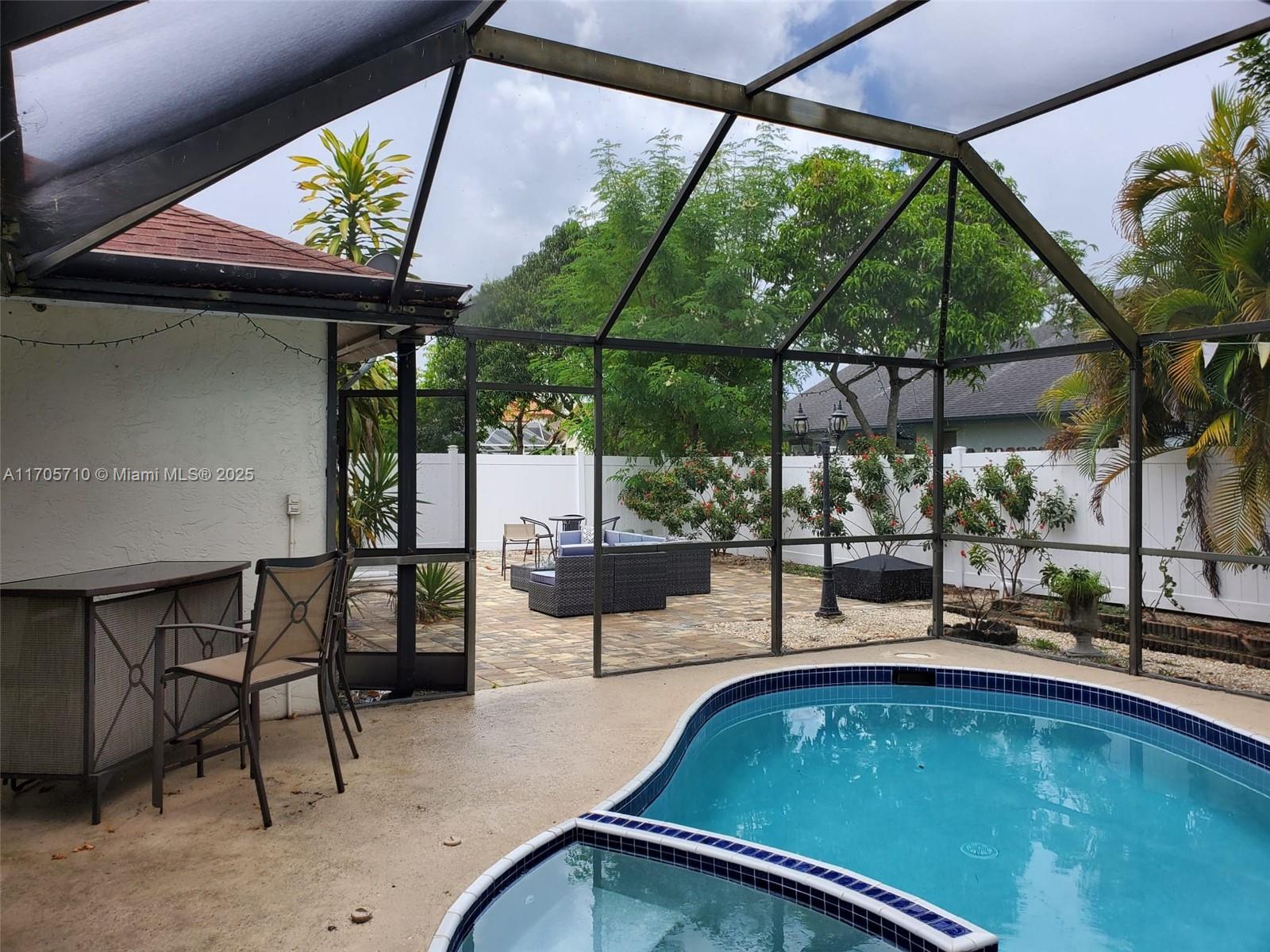 a view of a swimming pool with a patio