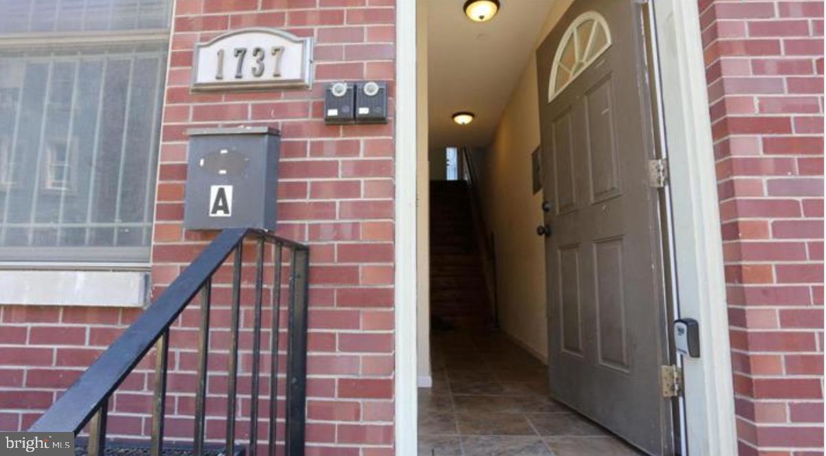 a view of a brick wall with staircase