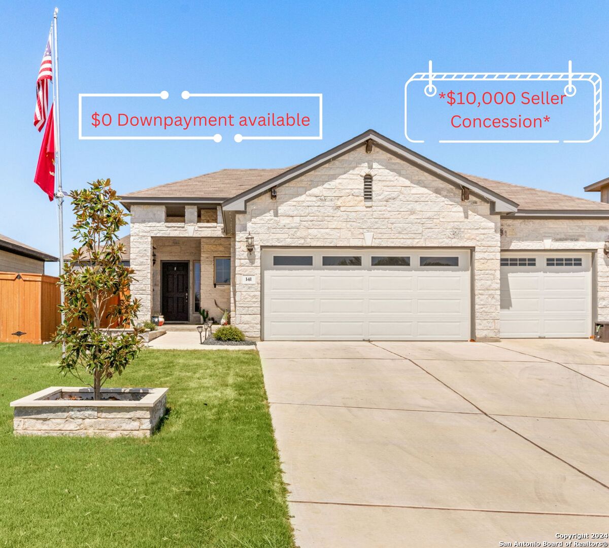 a view of the house with a yard and garage