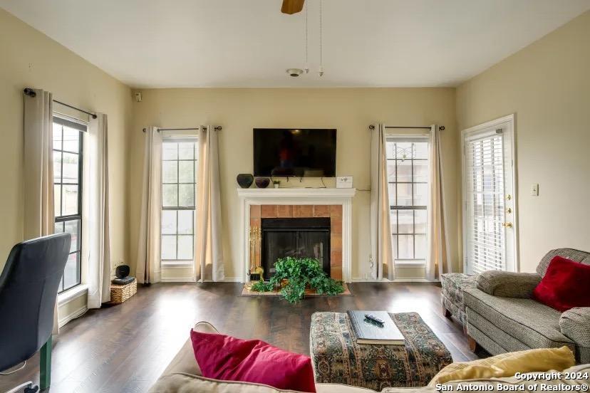 a living room with furniture fireplace and flat screen tv