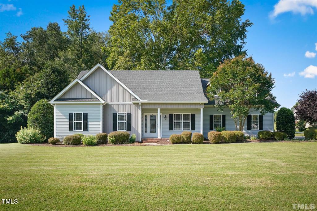 a front view of house with yard and green space