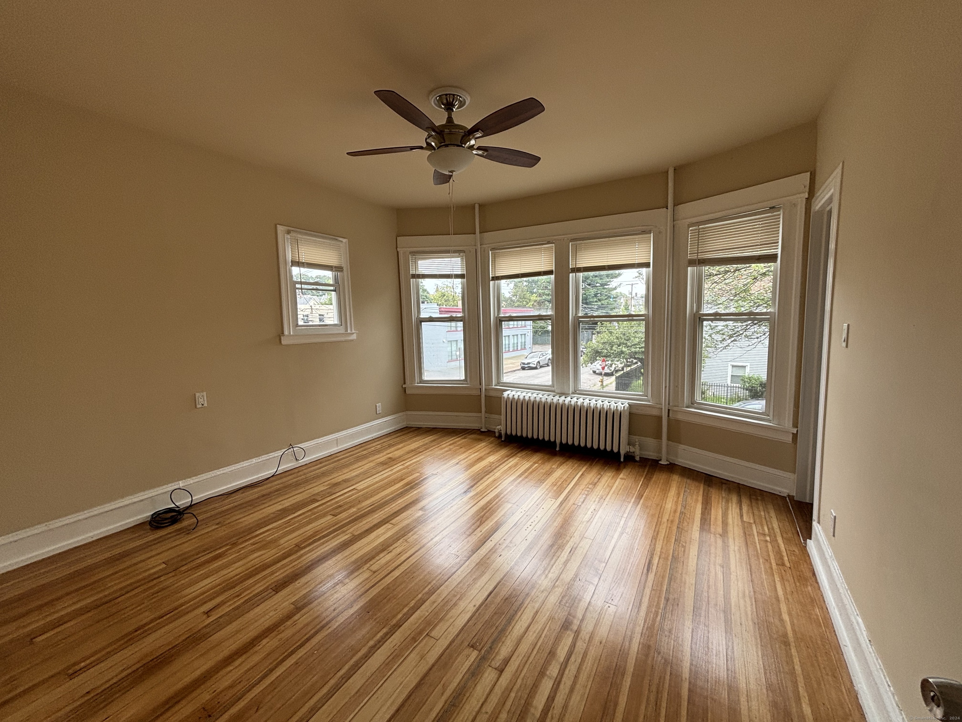 a view of wooden floor and windows in a room