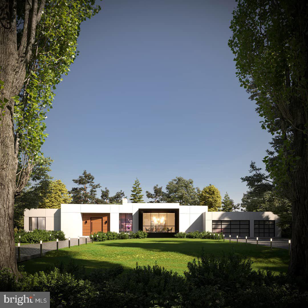 a view of a house with a big yard and large trees