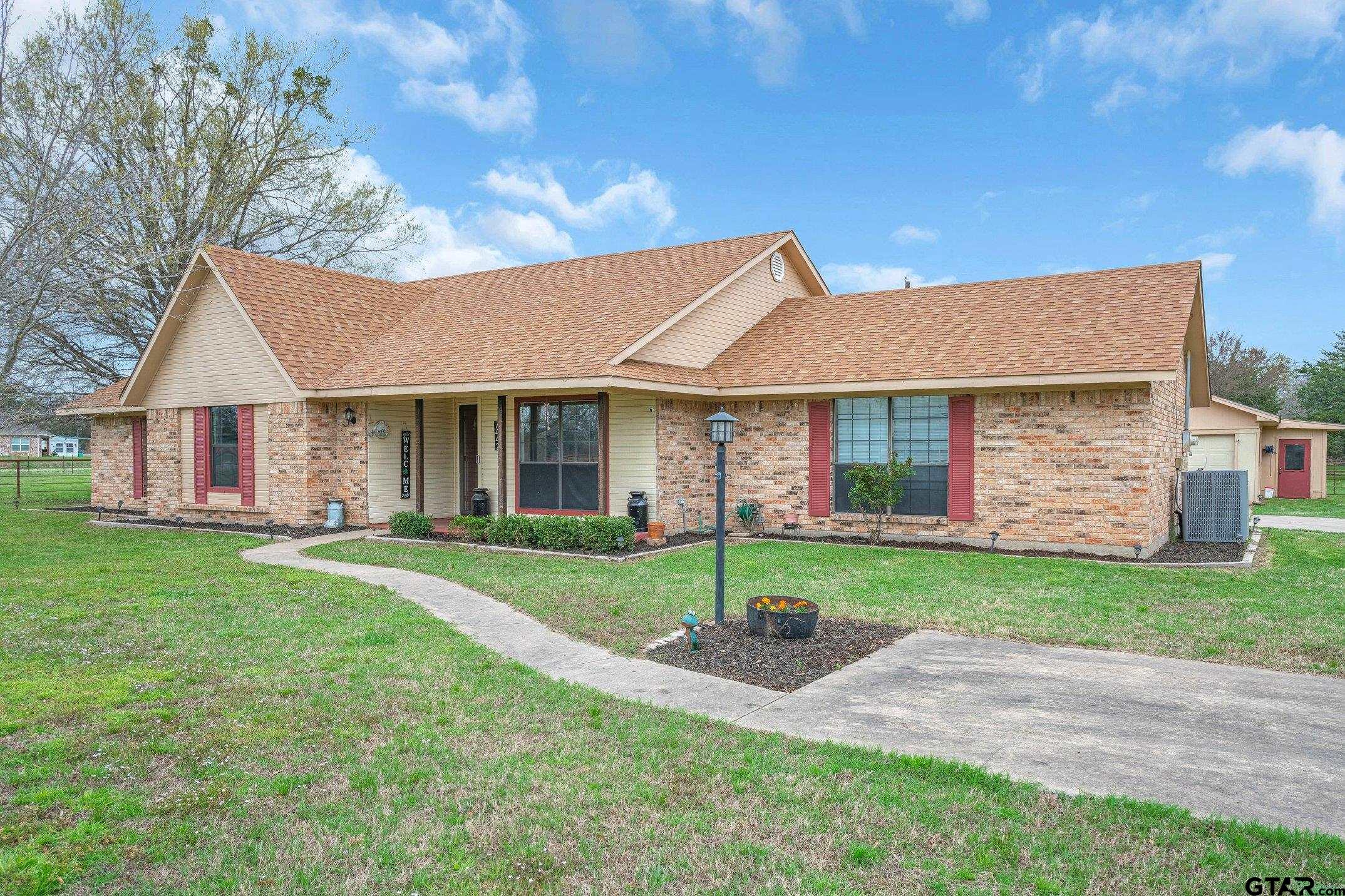 a front view of a house with a yard and porch