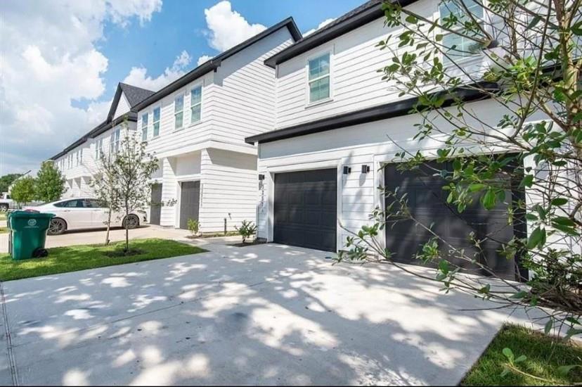 a view of a house with a yard and tree s